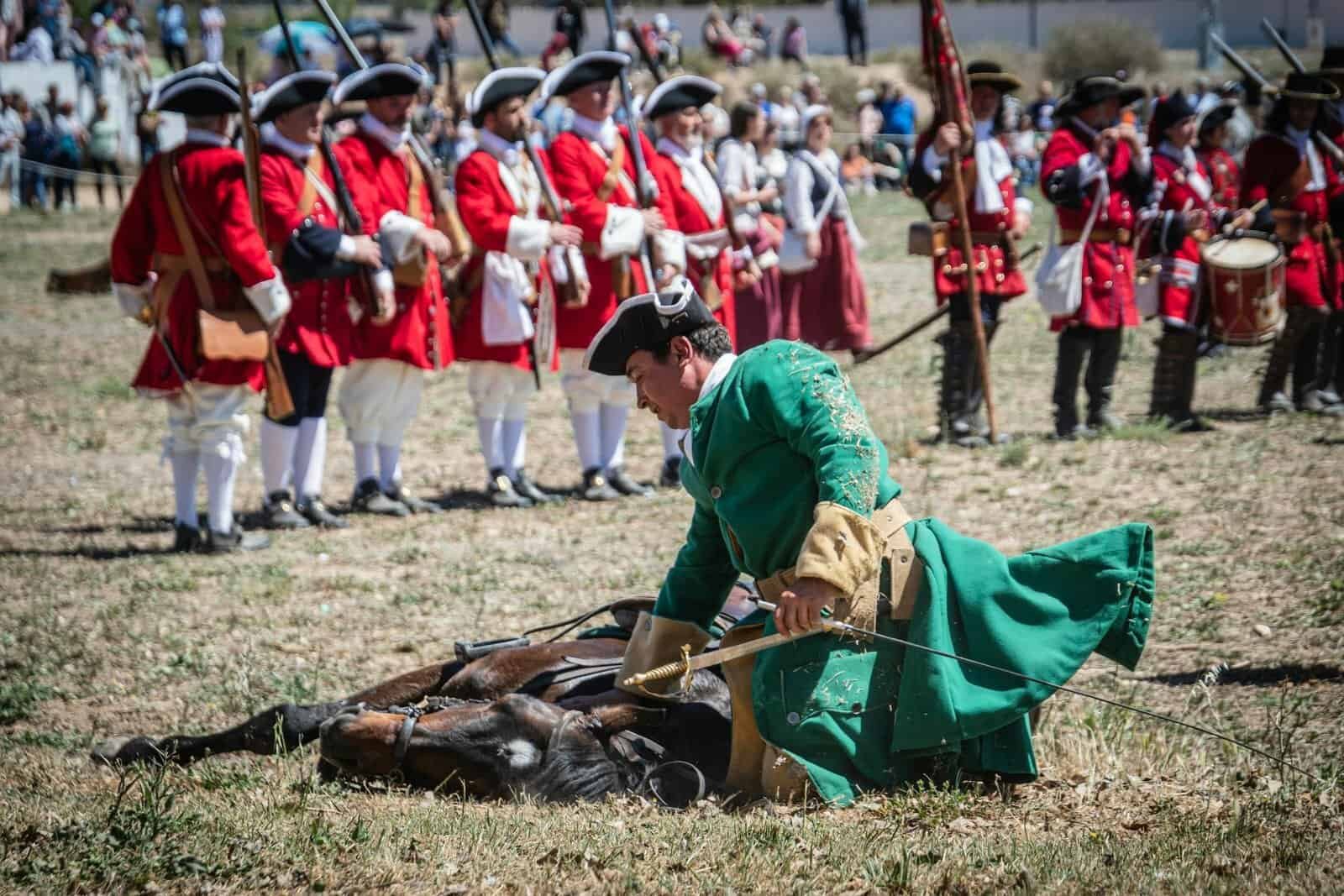 Dramatic capture of a historical battle reenactment in Almansa, Spain, featuring soldiers in period uniforms.